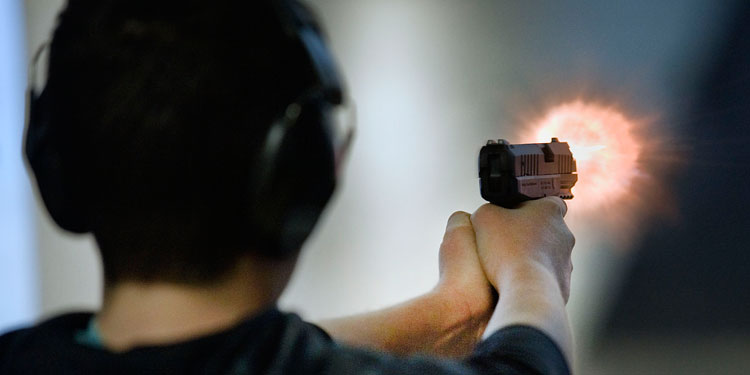 William Godkin, 13, fires the Walther PPX 9mm handgun that belongs to his father, Jeff Godkin.