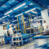 Blurred_forklift_and_factory_workers_SmartCropSixteenToNine